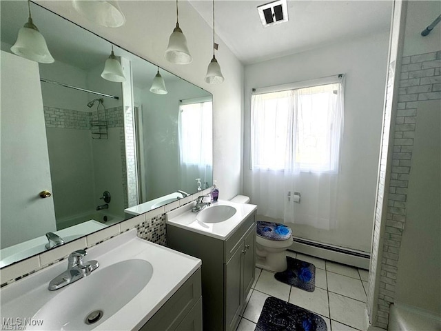 bathroom with a baseboard radiator, tile patterned flooring, visible vents, and a sink