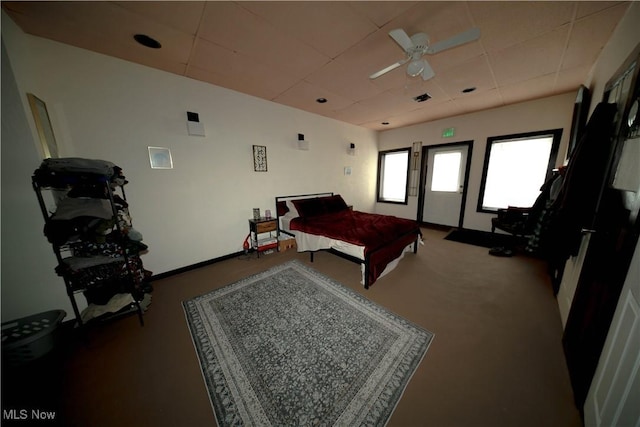 carpeted bedroom with baseboards and a drop ceiling