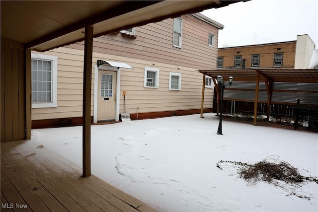 view of snow covered rear of property