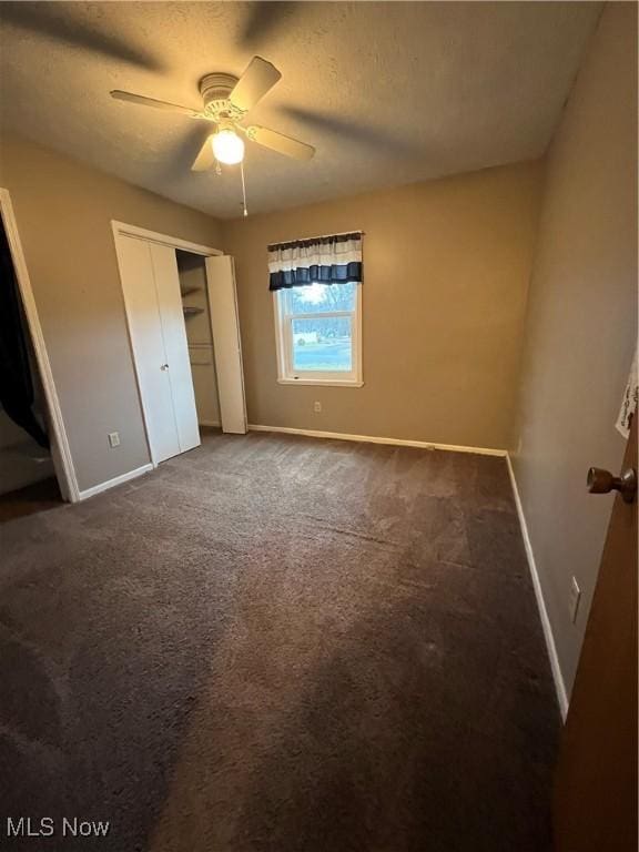 1025 Ohltown Rd, Youngstown, OH 44515 - unfurnished bedroom with baseboards, dark colored carpet, a closet, a textured ceiling, and ceiling fan