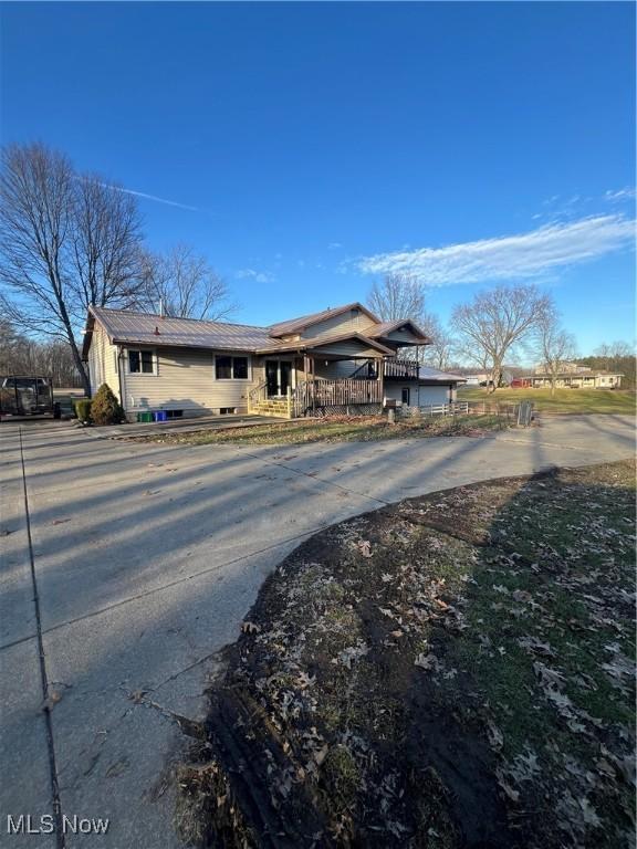 1025 Ohltown Rd, Youngstown, OH 44515 - view of front of house with concrete driveway and metal roof