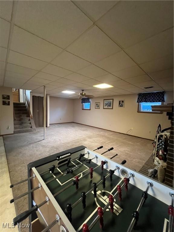 playroom featuring carpet and a drop ceiling