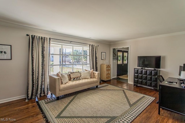 living area with ornamental molding, baseboards, and wood finished floors