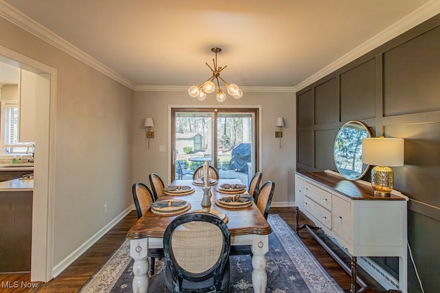 dining space with baseboards, a chandelier, dark wood finished floors, and crown molding