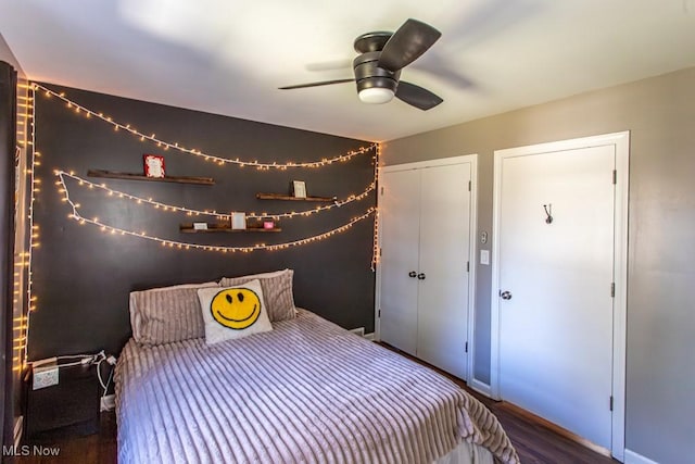 unfurnished bedroom featuring a ceiling fan, a closet, and wood finished floors