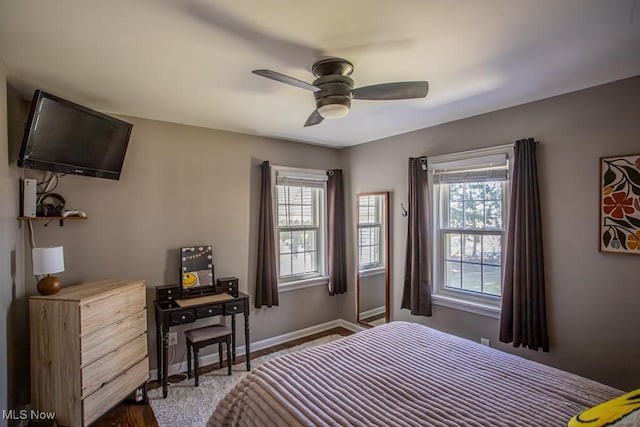 bedroom featuring a ceiling fan and baseboards