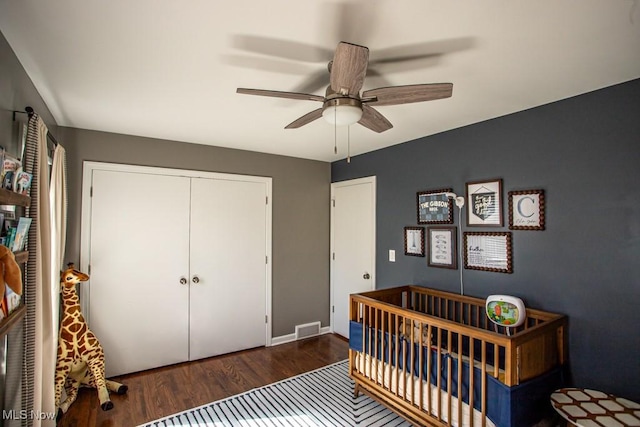 bedroom featuring baseboards, visible vents, ceiling fan, wood finished floors, and a closet