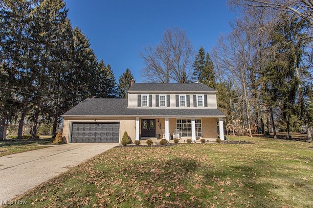 view of front of property featuring a garage, concrete driveway, covered porch, a front lawn, and brick siding