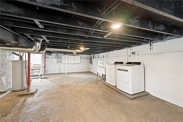 unfinished basement with water heater and independent washer and dryer