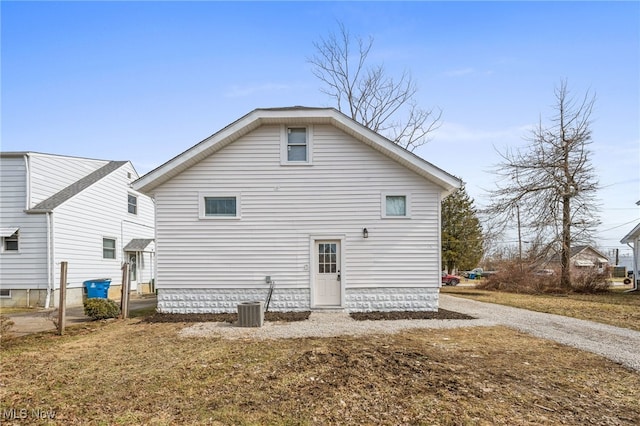 back of property with central AC and driveway