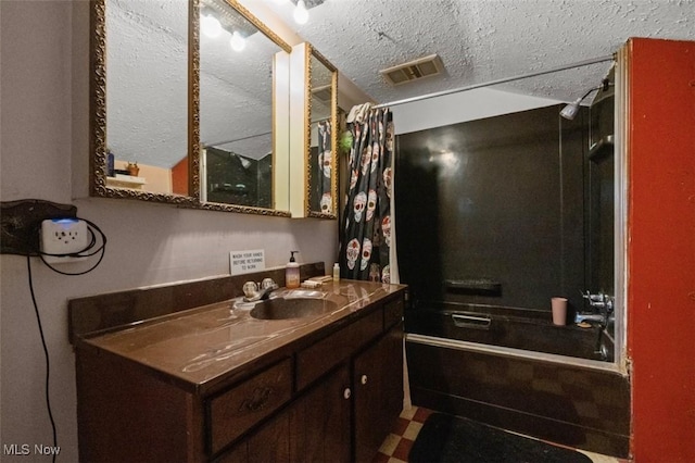 bathroom with a textured ceiling, vanity, visible vents, and shower / bathtub combination with curtain