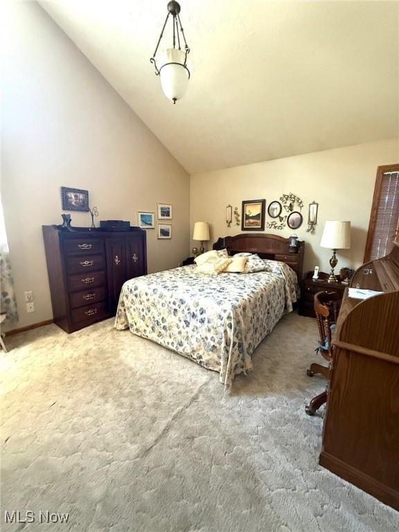 carpeted bedroom featuring vaulted ceiling