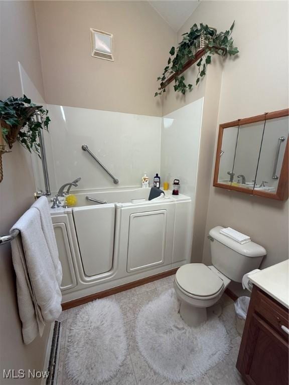 full bath with toilet, vaulted ceiling, vanity, and a bath