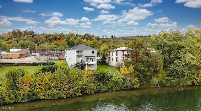 birds eye view of property featuring a water view and a view of trees