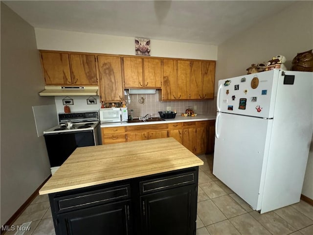 kitchen with decorative backsplash, brown cabinetry, light tile patterned flooring, white appliances, and under cabinet range hood