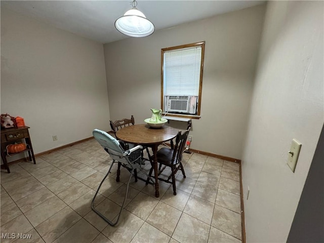 dining area featuring light tile patterned floors, baseboards, and cooling unit