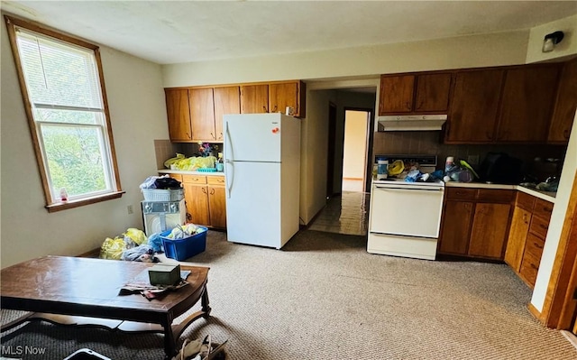 kitchen with light countertops, decorative backsplash, light carpet, white appliances, and under cabinet range hood