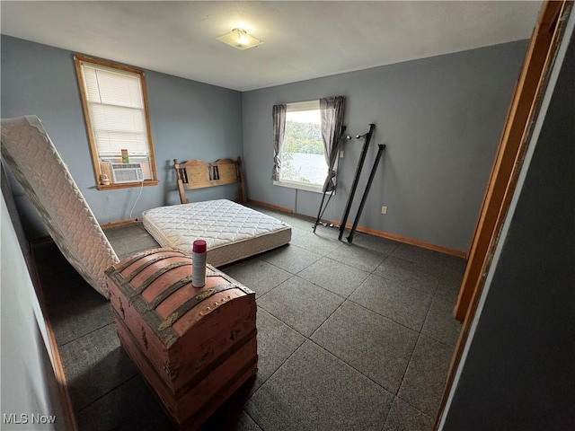 bedroom with cooling unit and baseboards