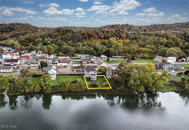 birds eye view of property with a water view, a wooded view, and a residential view