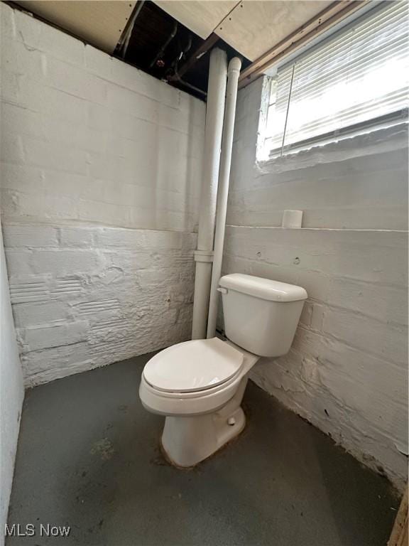 bathroom featuring toilet and concrete floors