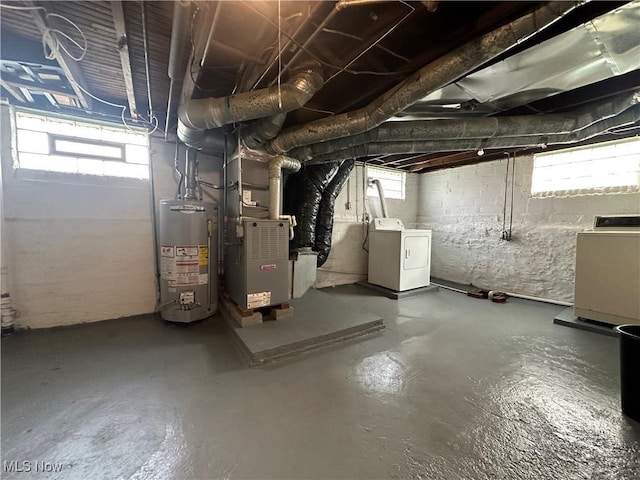 basement with water heater, independent washer and dryer, and heating unit