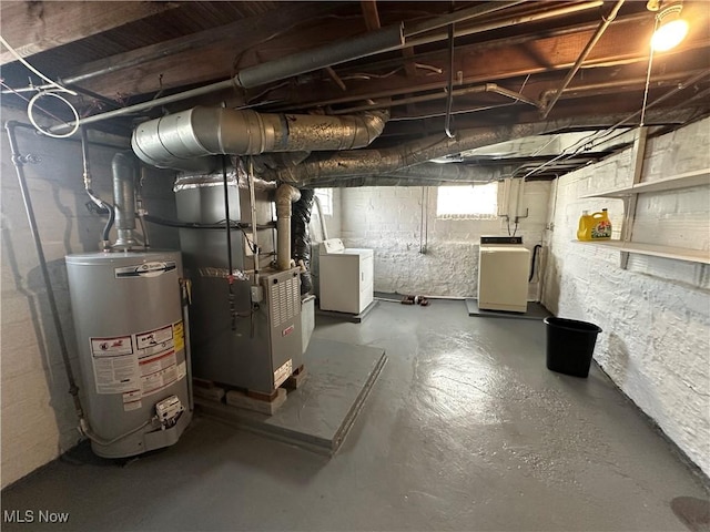 below grade area with independent washer and dryer, gas water heater, and heating unit