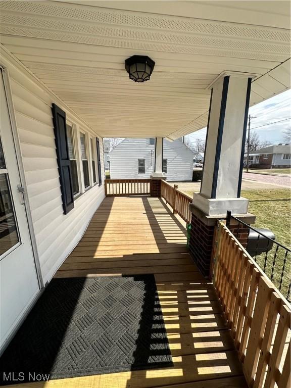 wooden terrace featuring covered porch