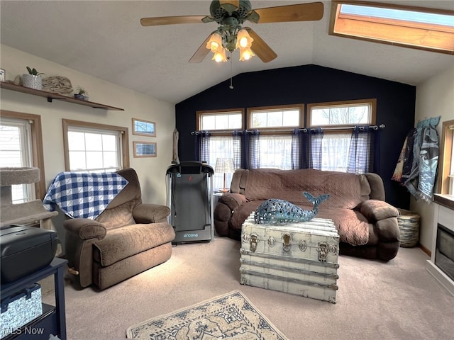 living room with lofted ceiling, a textured ceiling, a ceiling fan, and carpet flooring