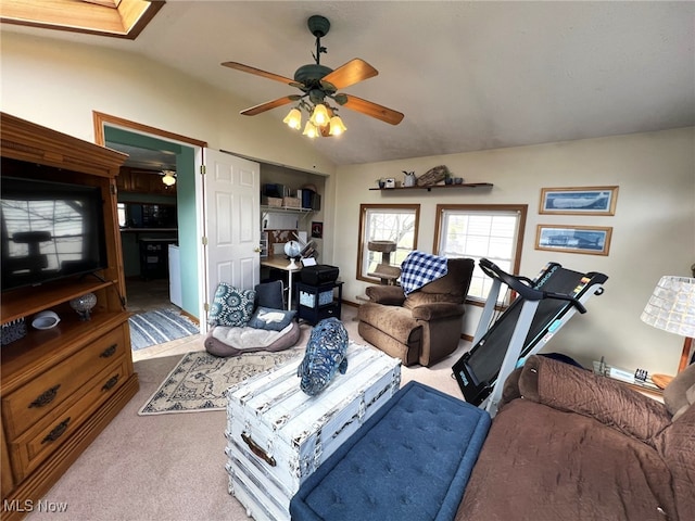 living room with vaulted ceiling, carpet flooring, and a ceiling fan