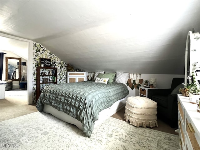 carpeted bedroom with lofted ceiling