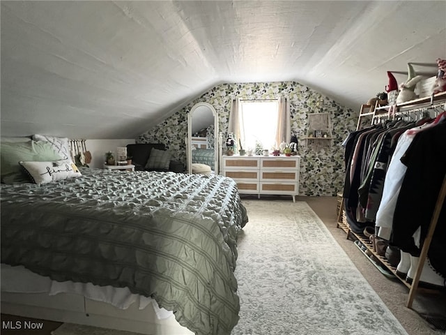 bedroom with carpet and vaulted ceiling