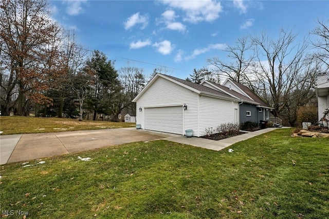 view of side of home with a garage, a lawn, and concrete driveway