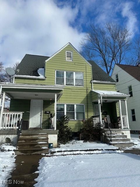 view of front facade with a porch and roof with shingles