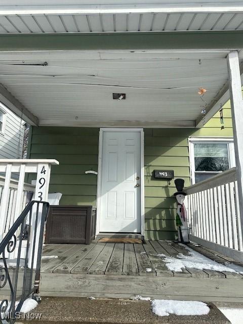 doorway to property featuring a porch