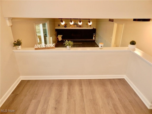 interior space with visible vents, baseboards, and wood finished floors