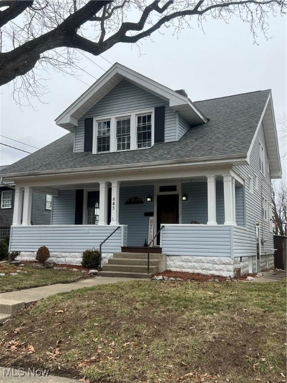 view of front of property with a porch and a shingled roof