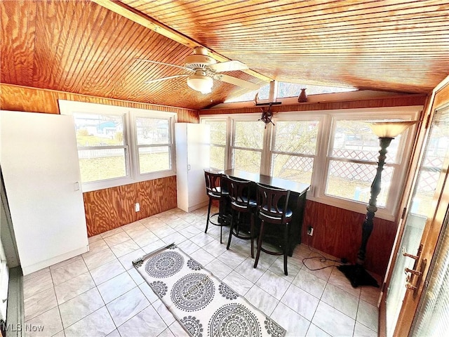 sunroom featuring lofted ceiling, wooden ceiling, and ceiling fan