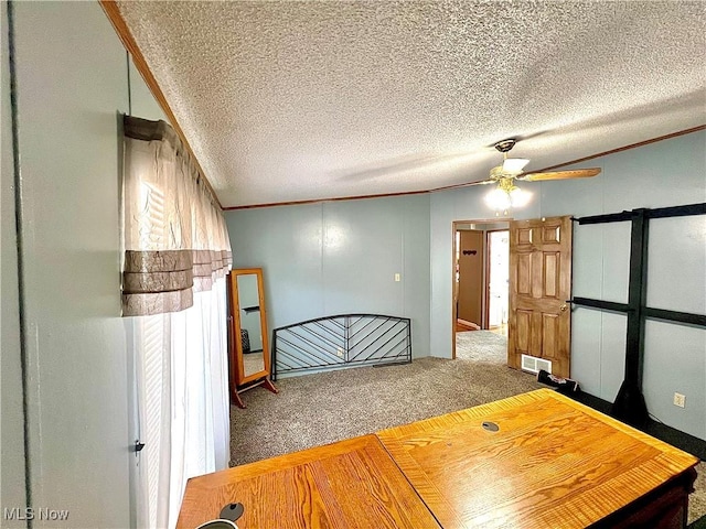 unfurnished bedroom featuring a textured ceiling, carpet flooring, visible vents, and crown molding