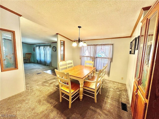 dining area with a chandelier, carpet floors, ornamental molding, and visible vents