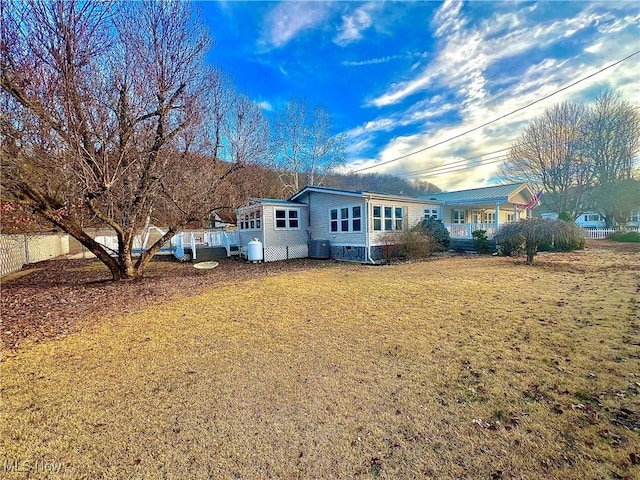 view of side of property featuring fence and a yard