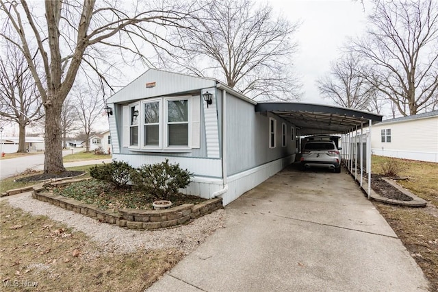 view of front of property featuring driveway and an attached carport