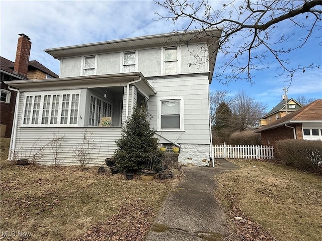 view of front of home featuring fence