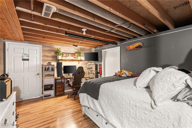 bedroom with light wood-type flooring and visible vents