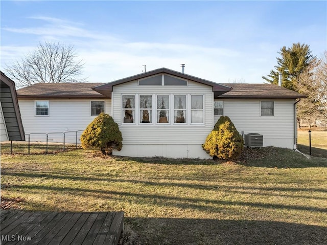 view of home's exterior with a lawn, fence, and central AC unit