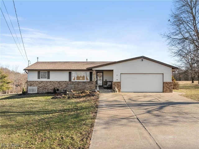 view of front of property with a front yard, concrete driveway, brick siding, and an attached garage