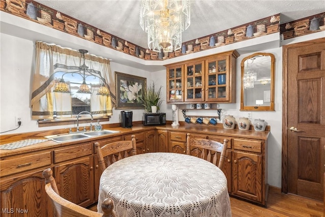 kitchen with black microwave, brown cabinets, and a sink