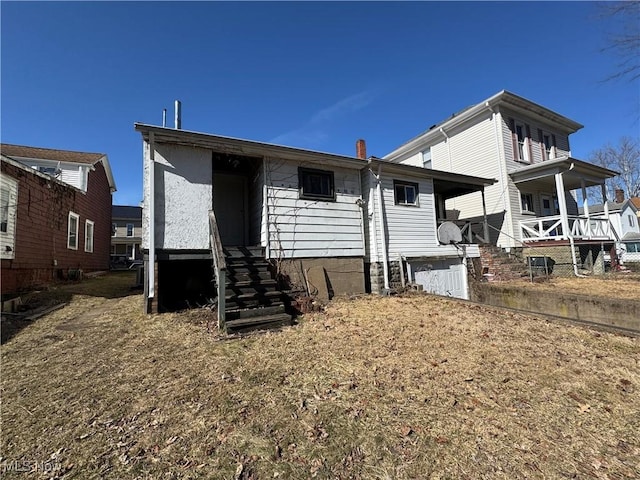 view of front of house with entry steps and a chimney