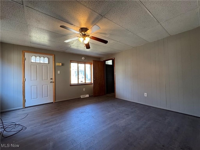 interior space featuring a paneled ceiling, visible vents, ceiling fan, and wood finished floors