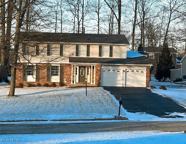 view of front facade with aphalt driveway and brick siding