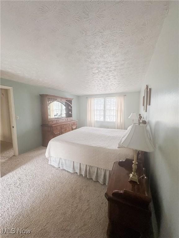 carpeted bedroom featuring a textured ceiling